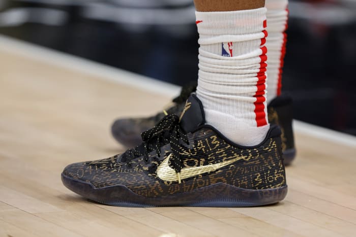 View of black and gold Nike Kobe shoes.